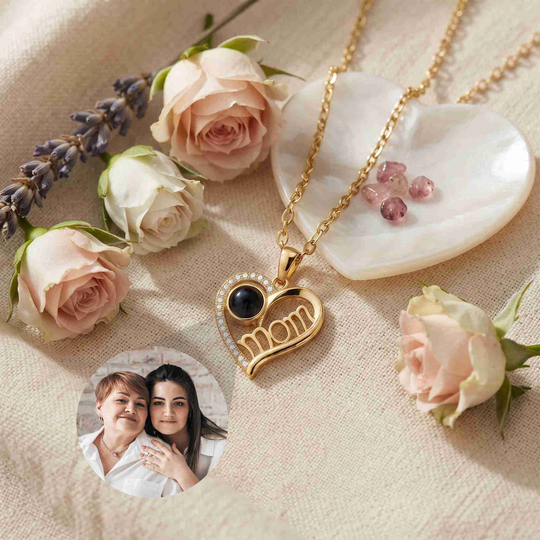 Heart-shaped photo projection necklace is elegantly displayed on a textured beige fabric background, surrounded by soft pink roses, lavender sprigs, and a heart-shaped dish.