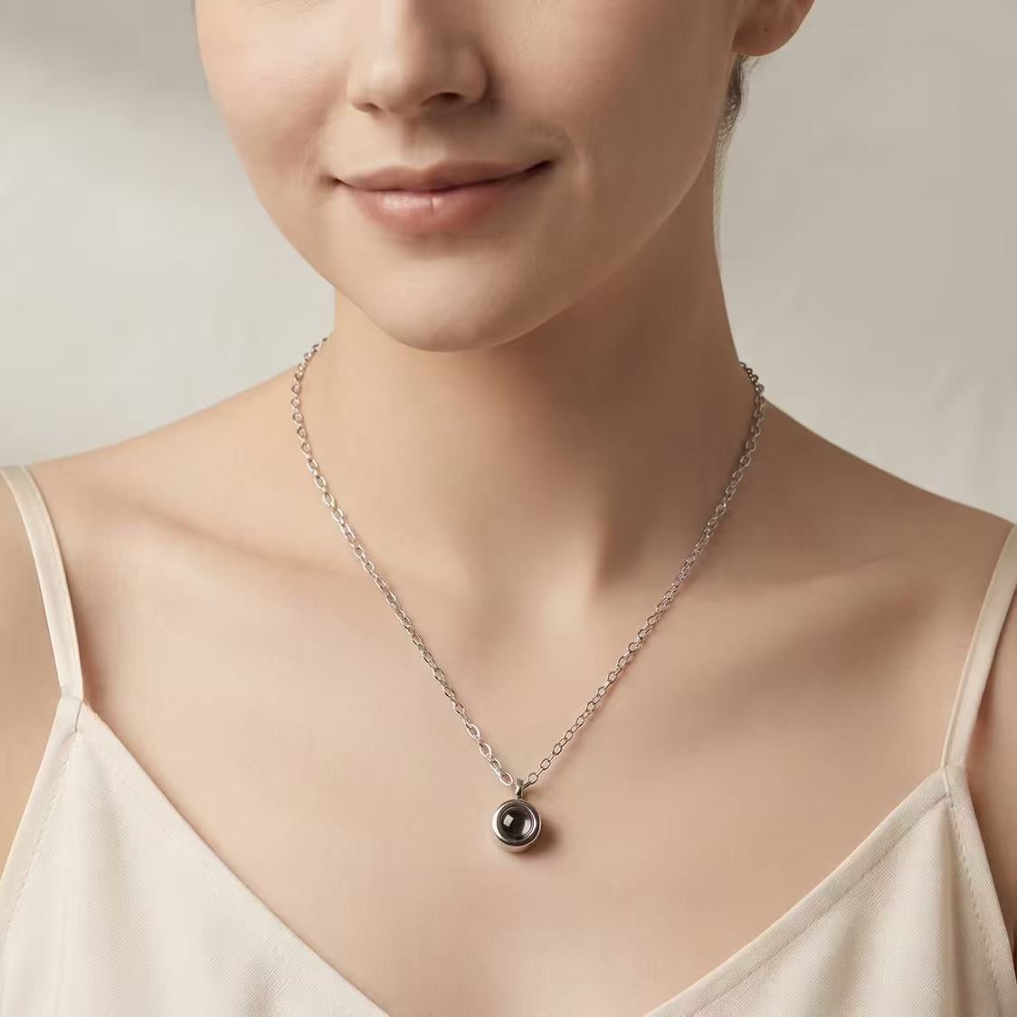 A circle photo projection necklace worn close to the heart